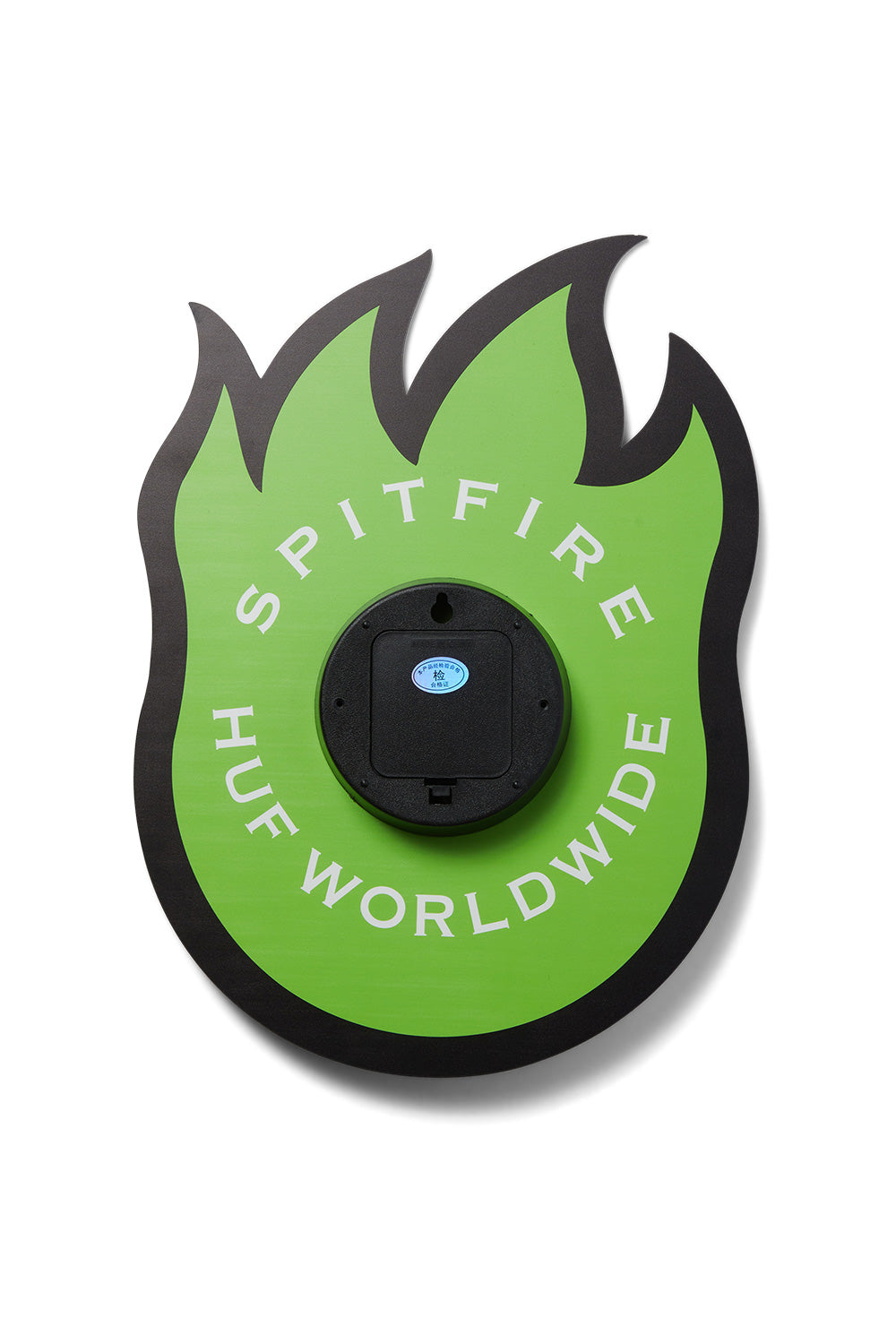 Rear view of the HUF X Spitfire Bighead wall clock, displaying the green acrylic backing, white circular SPITFIRE HUF WORLDWIDE text print, and the central black plastic battery movement housing with an integrated wall mount hole.