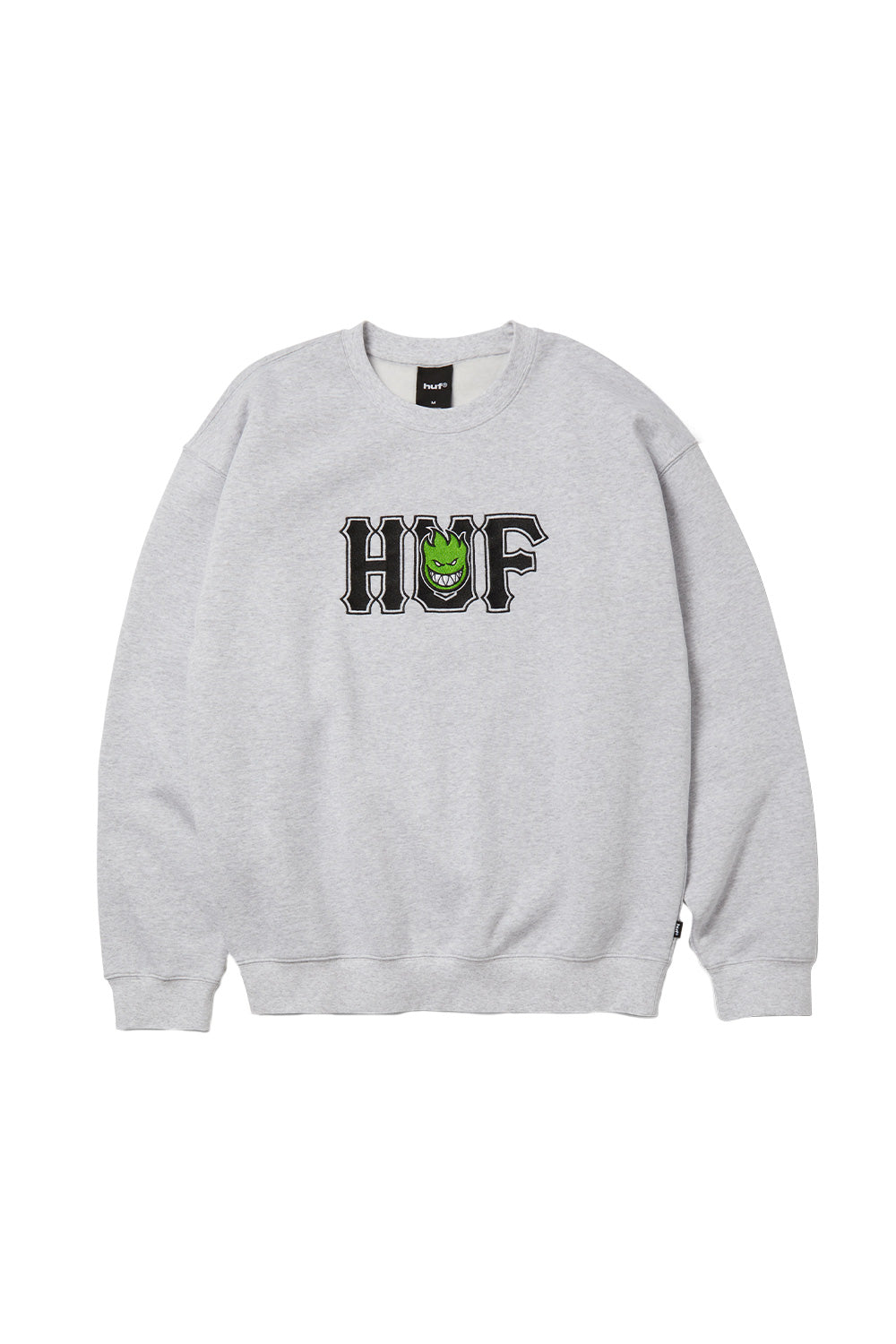 Front view of the HUF X Spitfire Union Crewneck Sweatshirt in heather grey, crafted from heavy 330 grams fleece fabric, featuring large black collegiate HUF embroidery across the chest with a bright green Spitfire Bighead flame logo integrated in the middle letter.