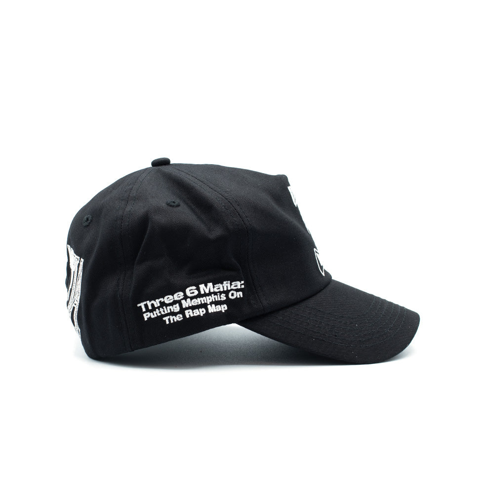 Right side profile studio view of the HUF x Three 6 Mafia Snapback cap, focusing on the embroidered bold white sans-serif text across the lower crown panel that reads "Three 6 Mafia: Putting Memphis On The Rap Map".