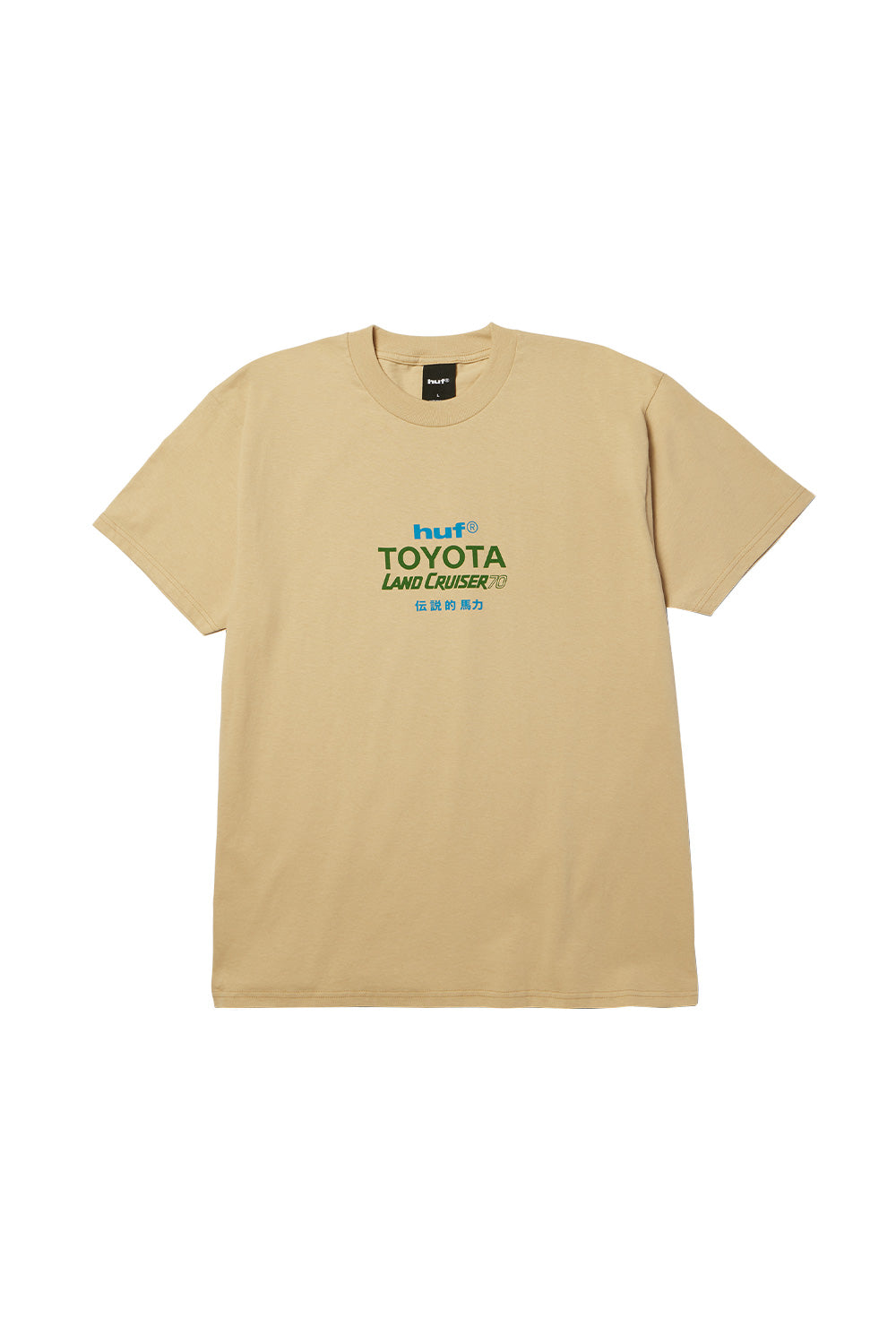 Front flat lay view of the sand-colored Huf X Toyota Land Cruiser 70 SS T-Shirt, featuring a relaxed crewneck cut, short sleeves, and a centered chest graphic print with stacked blue "huf®", dark green "TOYOTA", italicized "LAND CRUISER 70", and blue Japanese Kanji lettering.