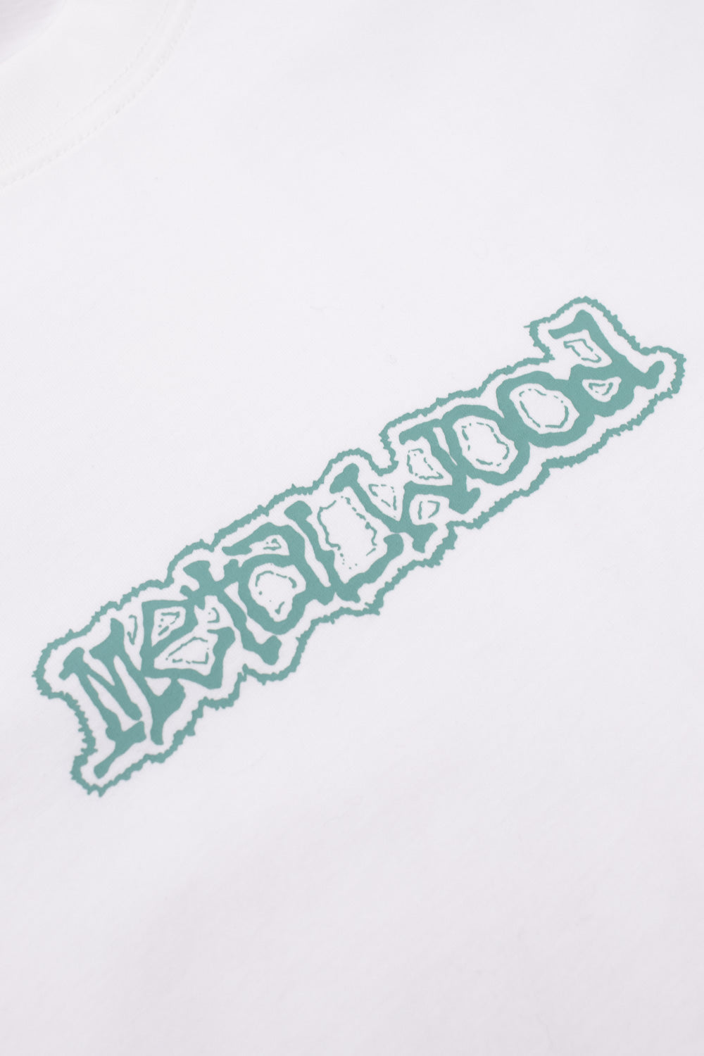 Detailed view of the Metalwood Studio Dewey chest print featuring stylized turquoise lettering on a white heavyweight T-shirt inspired by 90s golf and skate fashion