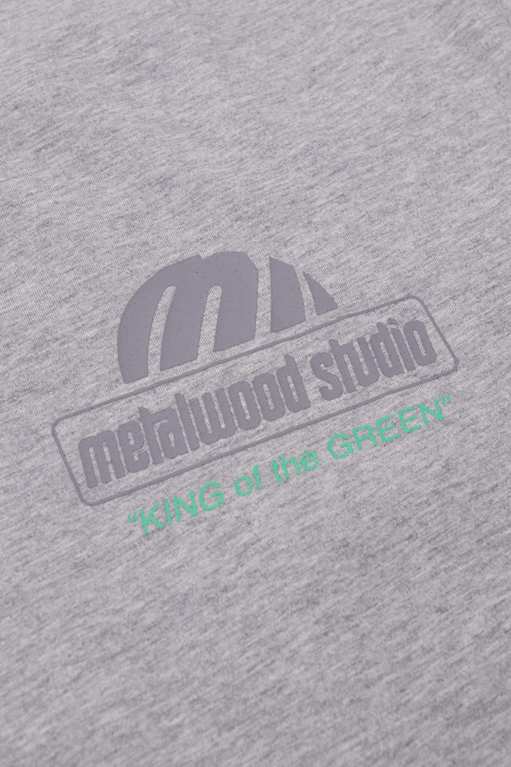 Detailed front graphic of Metalwood Studio T-shirt displaying King Of The Greens logo artwork, vintage golf-inspired typography and relaxed skatewear aesthetics