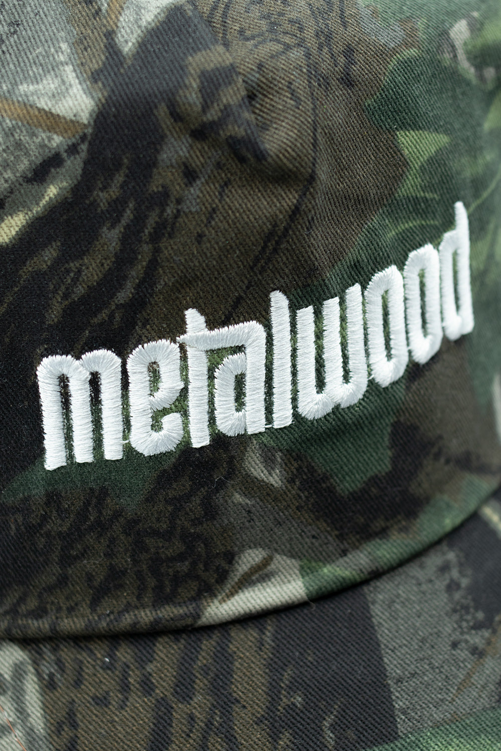 Stylish Metalwood Studio Metal Logo 5 Panel Cap Green Real Leaf Camo, cotton streetwear cap inspired by golf and skate culture with front embroidery.