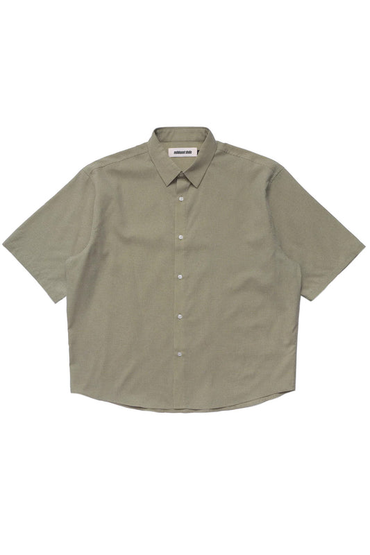 Oversized green button up shirt by Metalwood Studio crafted from a 70% polyester 30% cotton blend with a lightweight feel, classic collar and modern skate-golf aesthetic