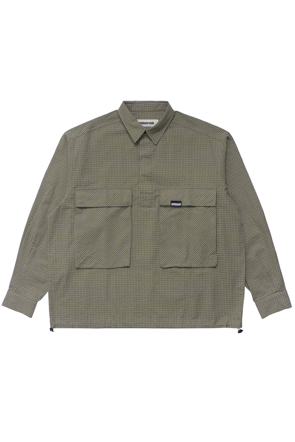 Metalwood Studio tactical overshirt in green and white plaid crafted from 100% cotton with large front flap pockets, relaxed boxy fit and contemporary skate-golf aesthetic
