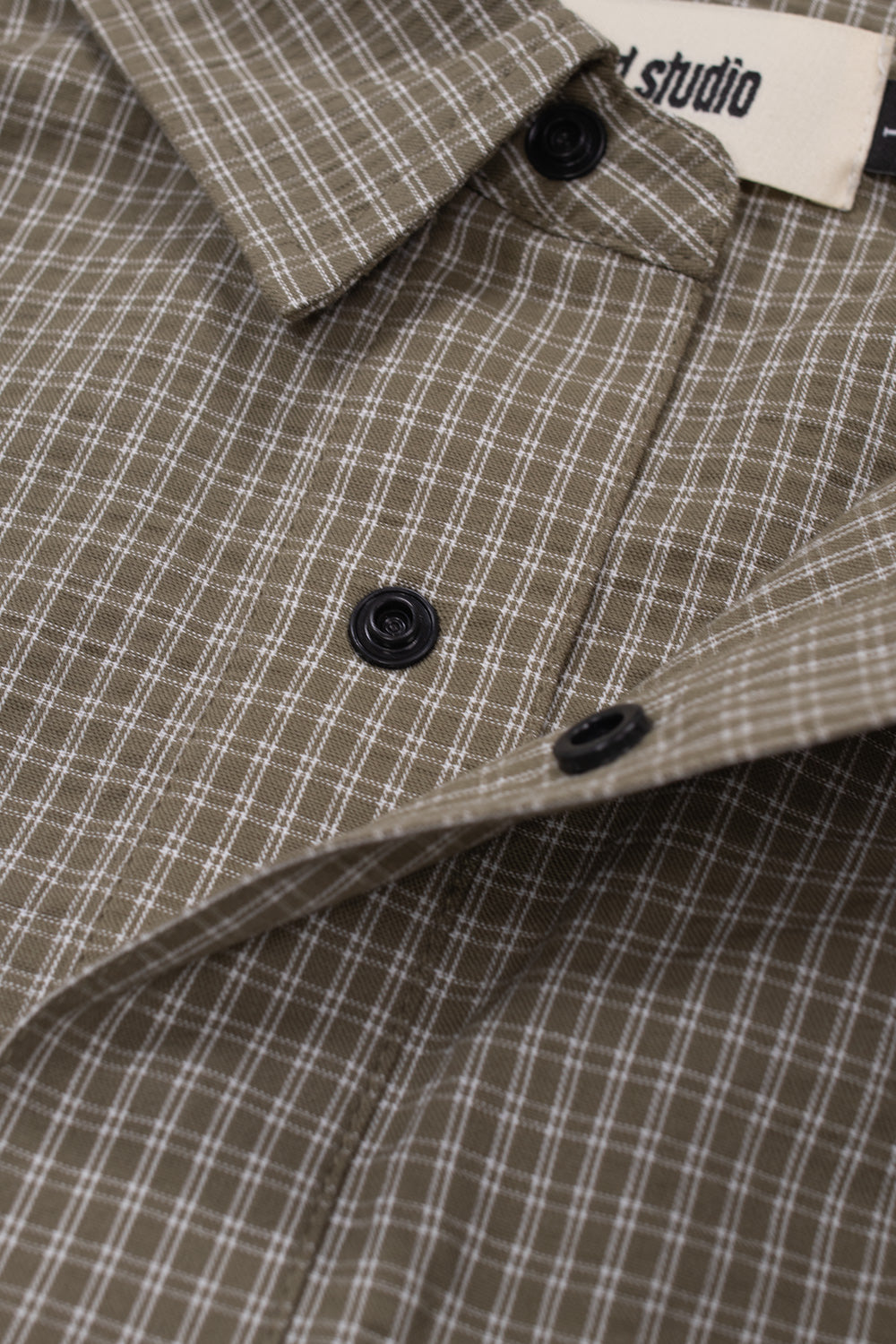 Detailed snap-button fastening on the Metalwood Studio Green White overshirt showcasing durable hardware and functional utility-inspired design