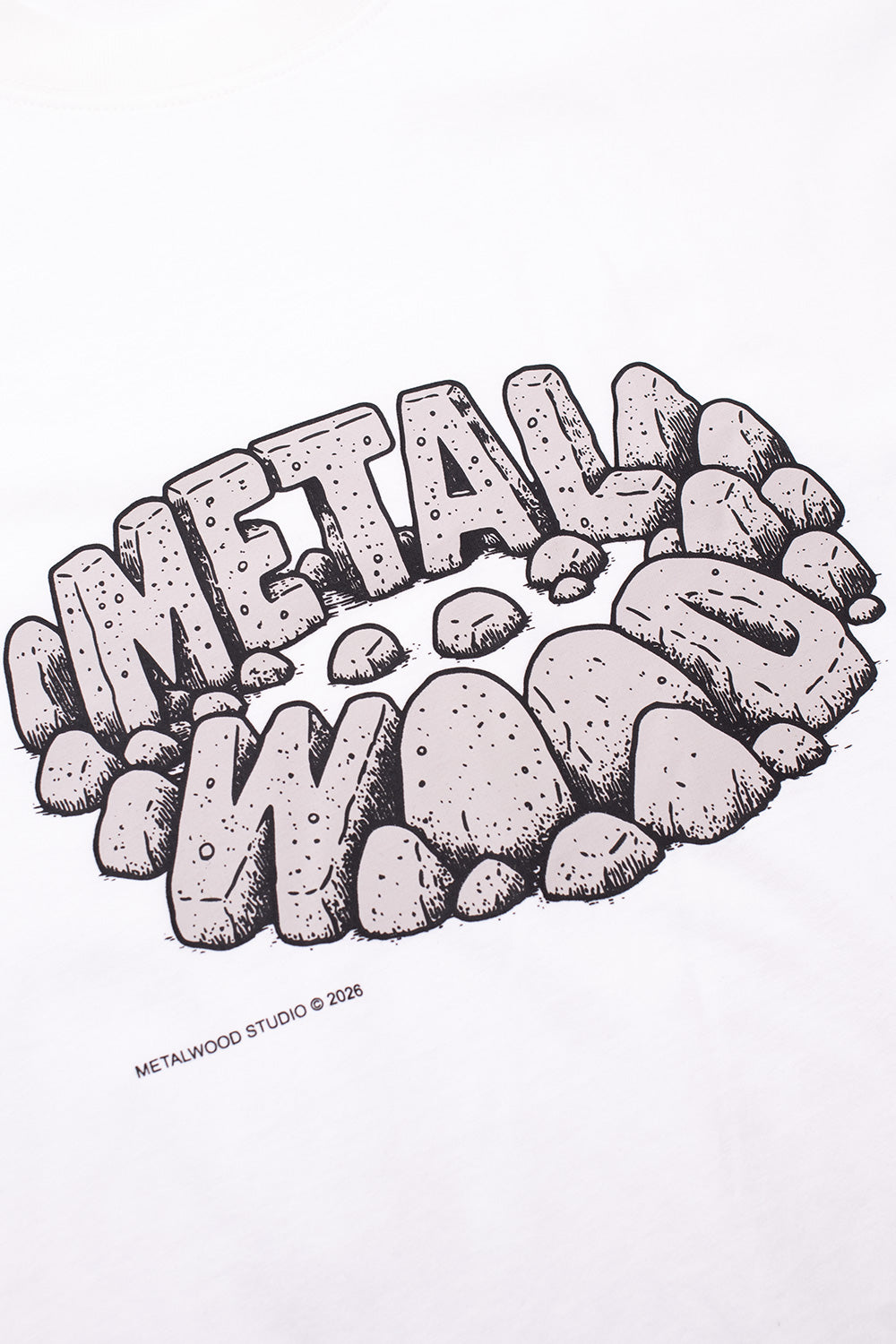Close-up of Metalwood Studio Stonehenge graphic on white cotton T-shirt, showcasing hand-drawn rock formation artwork, premium screen print detailing and retro golf-meets-skate culture aesthetics