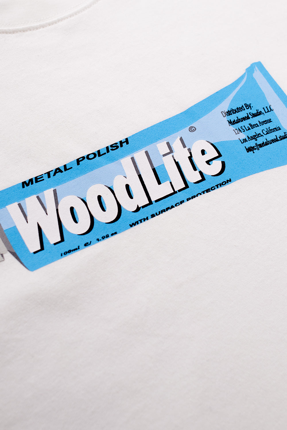 Close-up of the WoodLite print on the Metalwood Studio Woodlite T-Shirt White, showcasing high-quality front graphic on durable 100% heavy cotton fabric.”