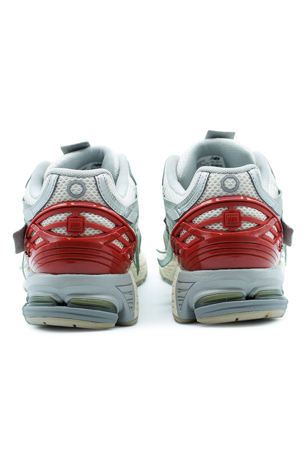 Rear detail of New Balance 1906A lifestyle runner showing red TPU heel cage, Stability Web support structure and segmented cushioning system for stability and shock absorption