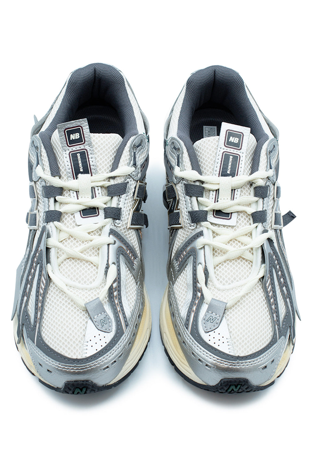 Side profile of the New Balance 1906A M1906AD in Silver Metallic, Castlerock and Gold Metallic featuring a deconstructed Y2K running silhouette, breathable mesh upper, layered synthetic panels, ABZORB cushioning and signature N-Lock support system.