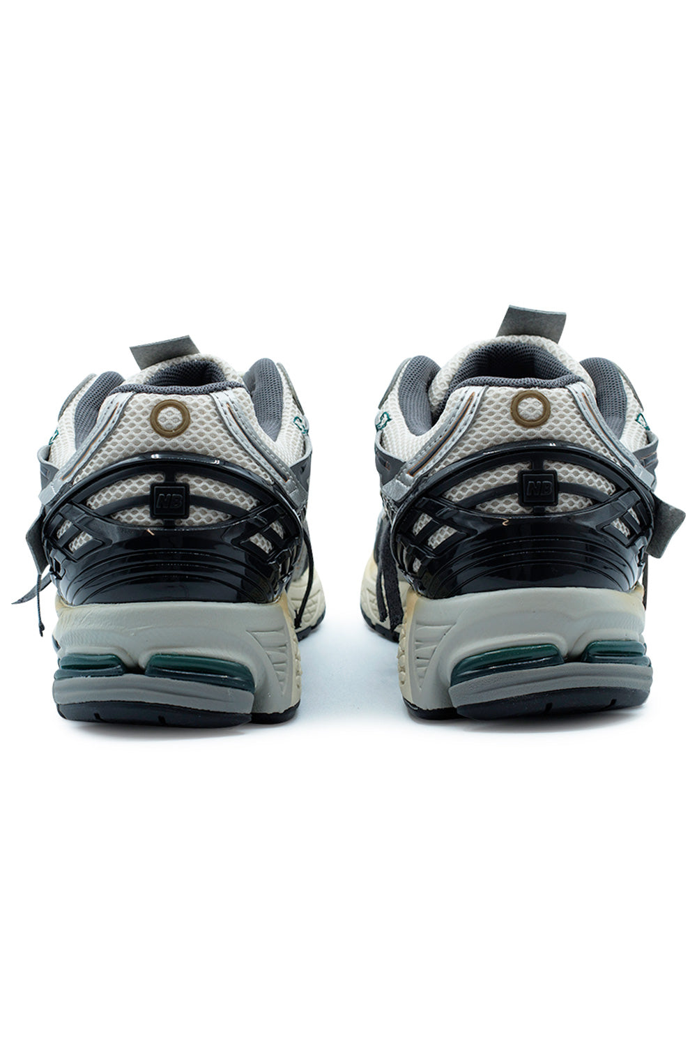 Rear angle of the New Balance 1906A M1906AD highlighting the glossy TPU heel cage, ABZORB SBS heel cushioning, padded collar, breathable mesh construction and performance-focused lifestyle sneaker architecture.