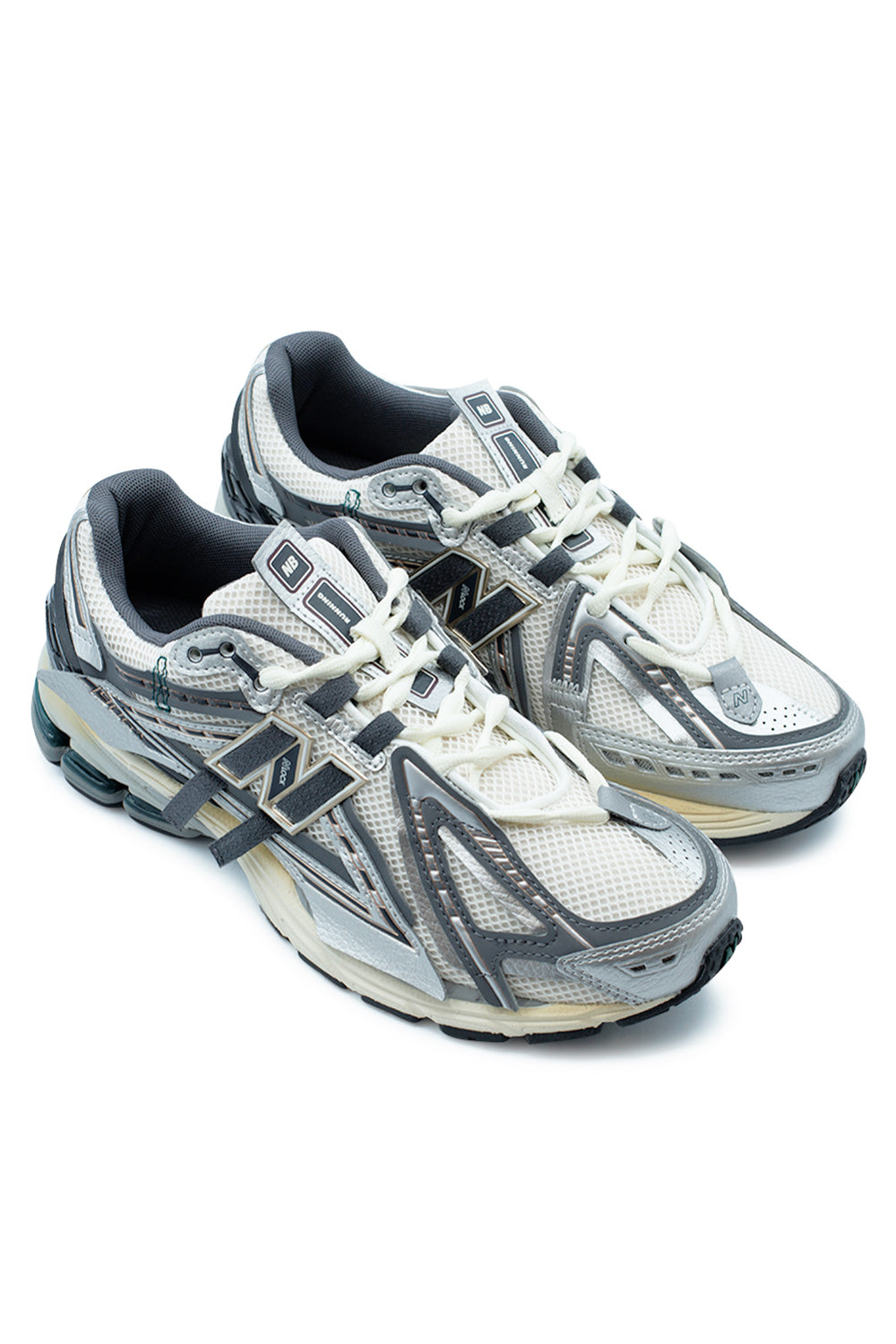 Angled pair of New Balance 1906A Silver Metallic sneakers displaying layered metallic overlays, Castlerock detailing, Gold Metallic accents, technical Y2K runner aesthetics, N-Lock midfoot support and premium everyday comfort technology.