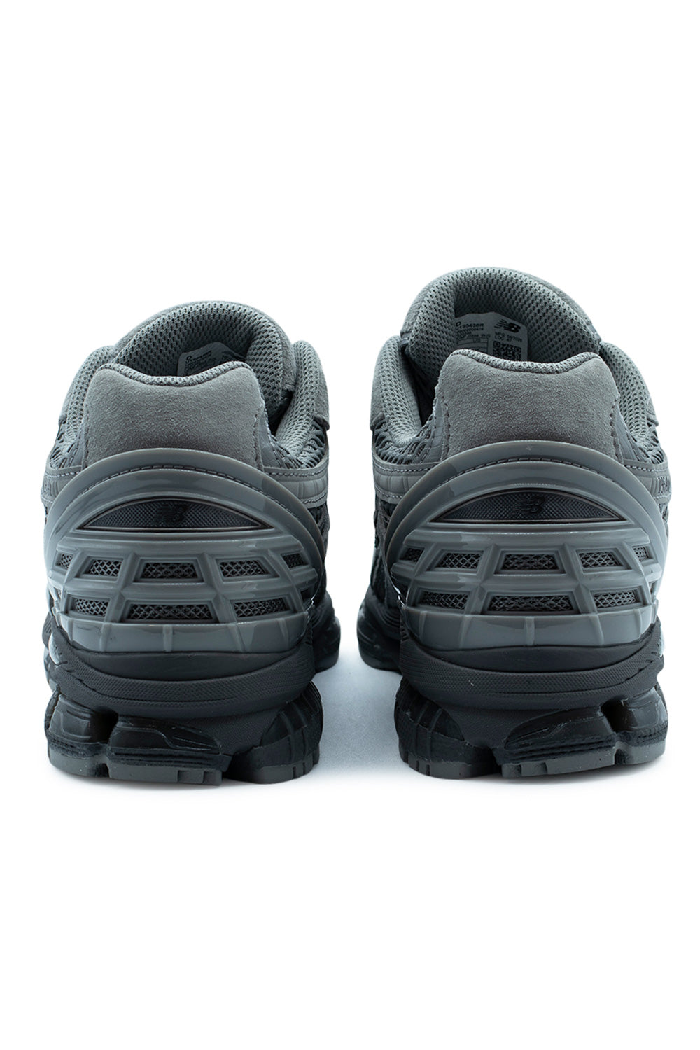Rear heel view of the New Balance 1954R sneakers, displaying the TPU heel cage support structure and segmented black ABZORB shock-absorbing sole unit.
