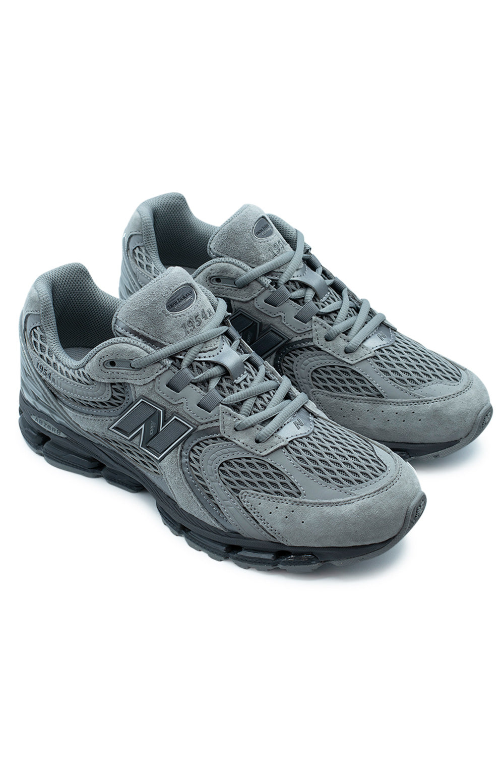 Studio shot of a pair of New Balance 1954R Slate Grey / Castlerock sneakers angled together, showing the technical Y2K runner silhouette.
