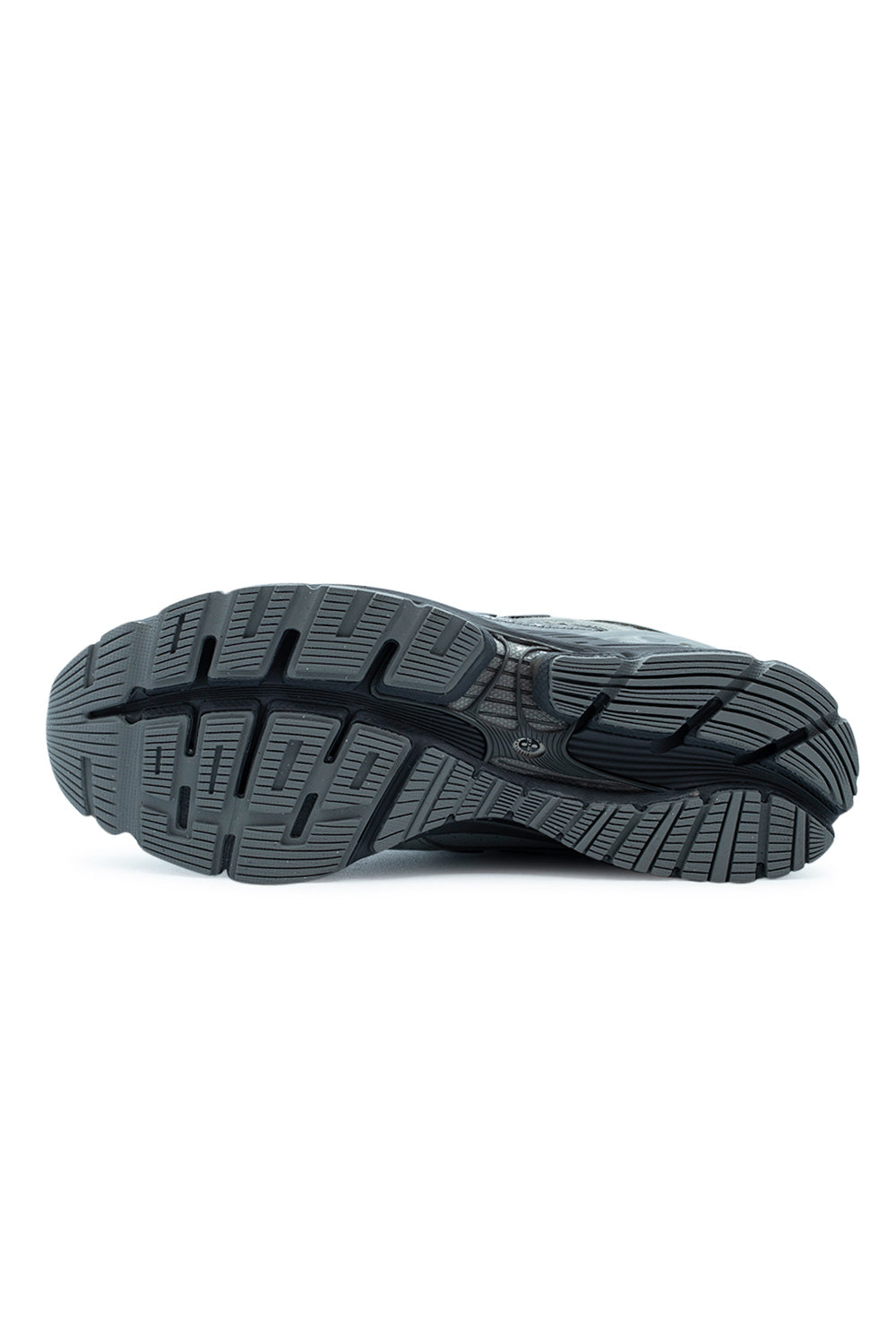 Full view of the deeply segmented dark grey rubber outsole of the New Balance 1954R sneaker, showing the multi-directional traction pattern.