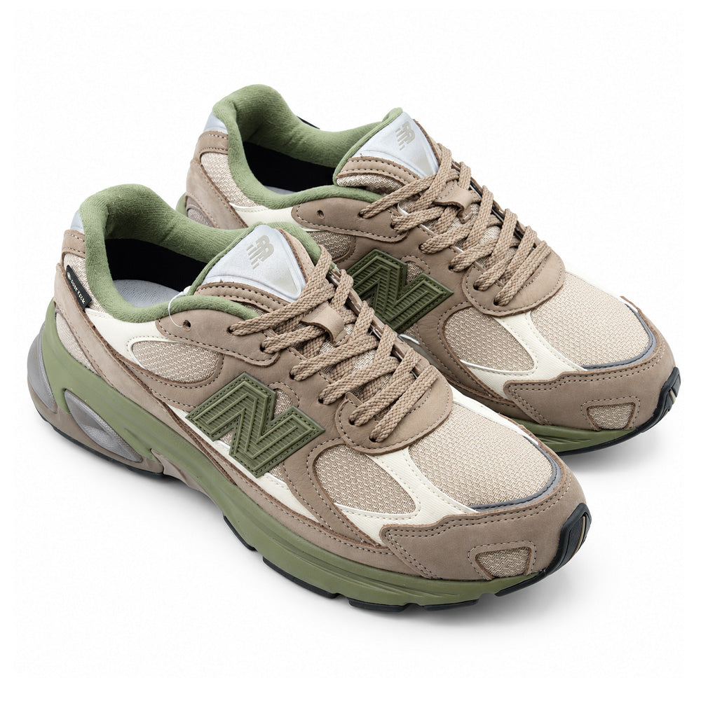 Three-quarter studio perspective of the pair of New Balance 2010 (GORE-TEX) shoes in the Mushroom / Timberwolf colorway, displaying the dynamic layered running silhouette, rugged rubberized mudguard accents, trail-ready technical GORE-TEX weatherproofing, and dual-density cushioned ABZORB sole units.