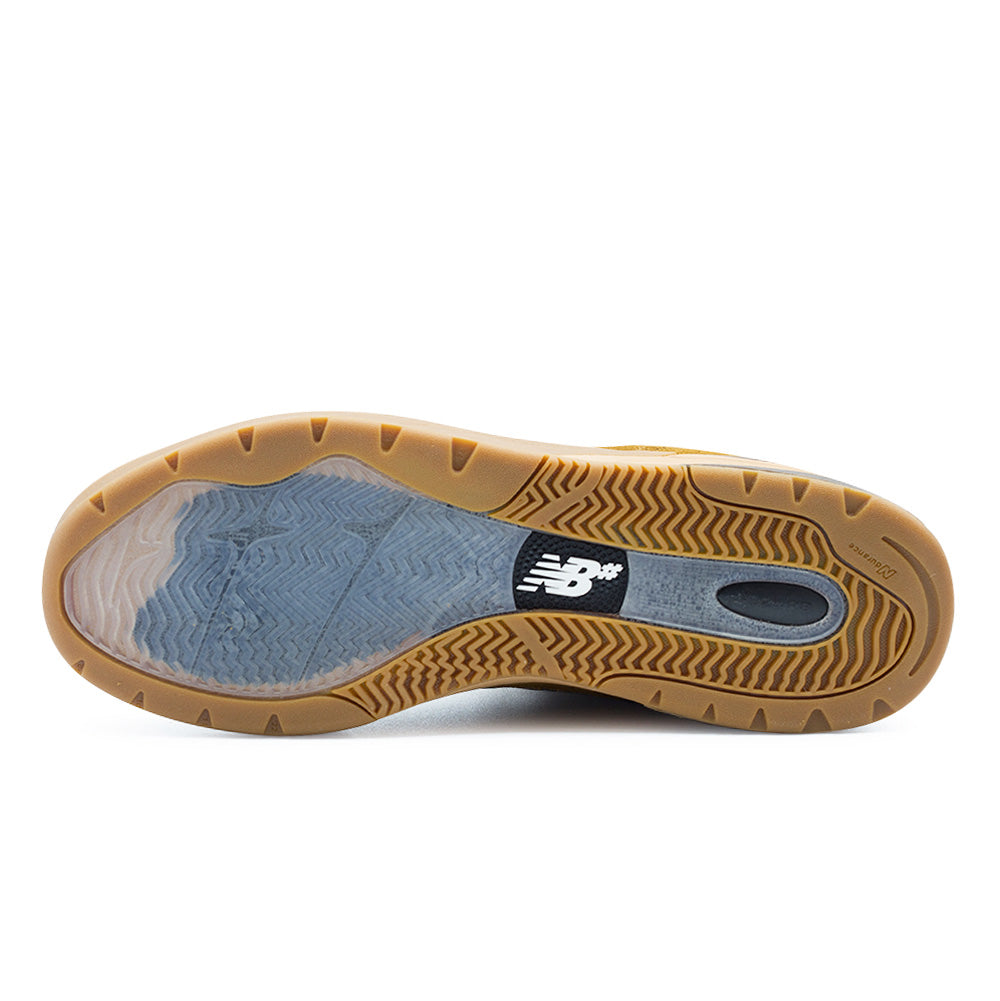 Full bottom view of the New Balance Numeric Andrew Reynolds 933 outsole, displaying the semi-translucent herringbone forefoot traction pad, gum Ndurance rubber perimeter with directional wave grooves, and a central stability shank window featuring embossed ABZORB branding and the NB# logo badge.