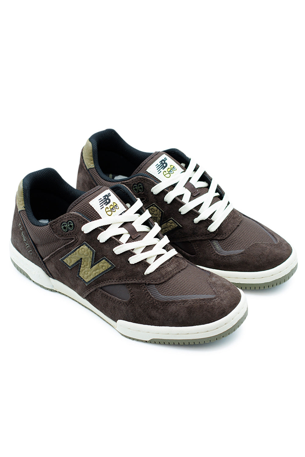 Side view of New Balance Numeric x Krooked Tom Knox 600 brown skateboarding shoes featuring leather M emblem and debossed flower heel tab.