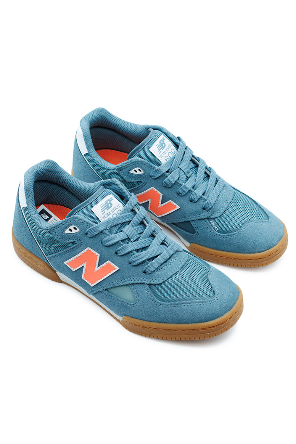 Angled view of New Balance Numeric Tom Knox 600 Salt Water Tangerine Heat low-top skate sneakers with gum outsole, Tom Knox signature model, and premium materials