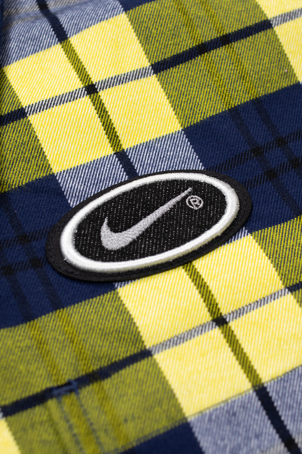 Nike SB Koston Flannel Shirt Midnight Navy Speed Yellow, men’s skatewear flannel with reflective Swoosh print on the back and heritage branding.
