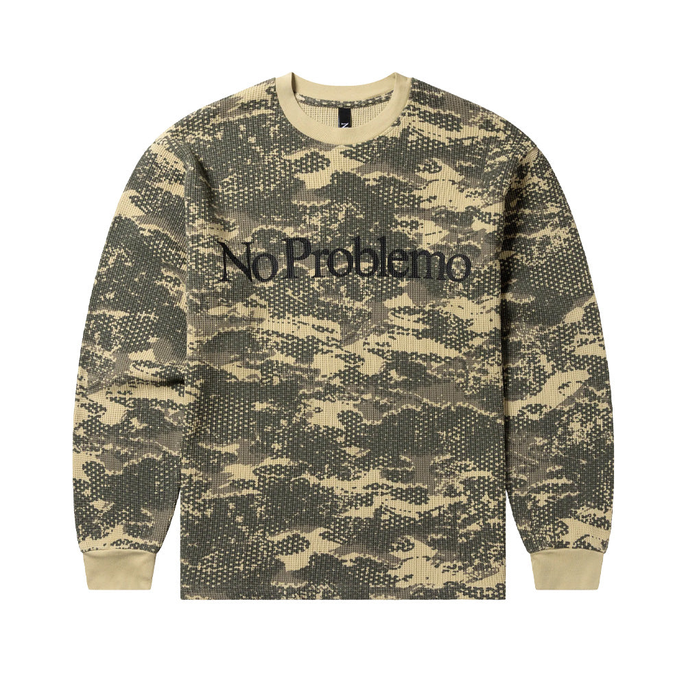 Front flat lay studio view of the Aries No Problemo Forest Waffle Long Sleeve T-Shirt in Sand, showcasing a textured thermal waffle-knit cotton crewneck top patterned with an all-over digital woodland camouflage print in earthy sand, taupe, and khaki green, accented by contrast sand rib-knit collar and cuffs, finished with bold black serif "No Problemo" logo lettering printed across the chest.