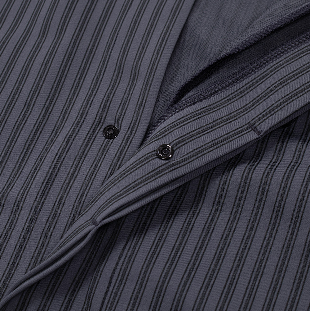 Close-up shot of the concealed front button placket on the Oakley FGL Fuel LS Shirt, slightly opened to display the smooth interior lining, neat seam finishing, and low-profile black metallic snap fasteners.