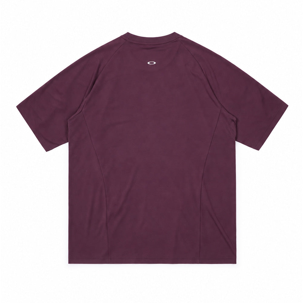 Back flat lay studio perspective of the Oakley FGL Union SS Tee 6.7 in Rouge, displaying the ergonomic raglan sleeve cut with side panelling, clean drop-tail hemline, and a printed metallic silver Oakley Ellipse logo centered below the rear collar.