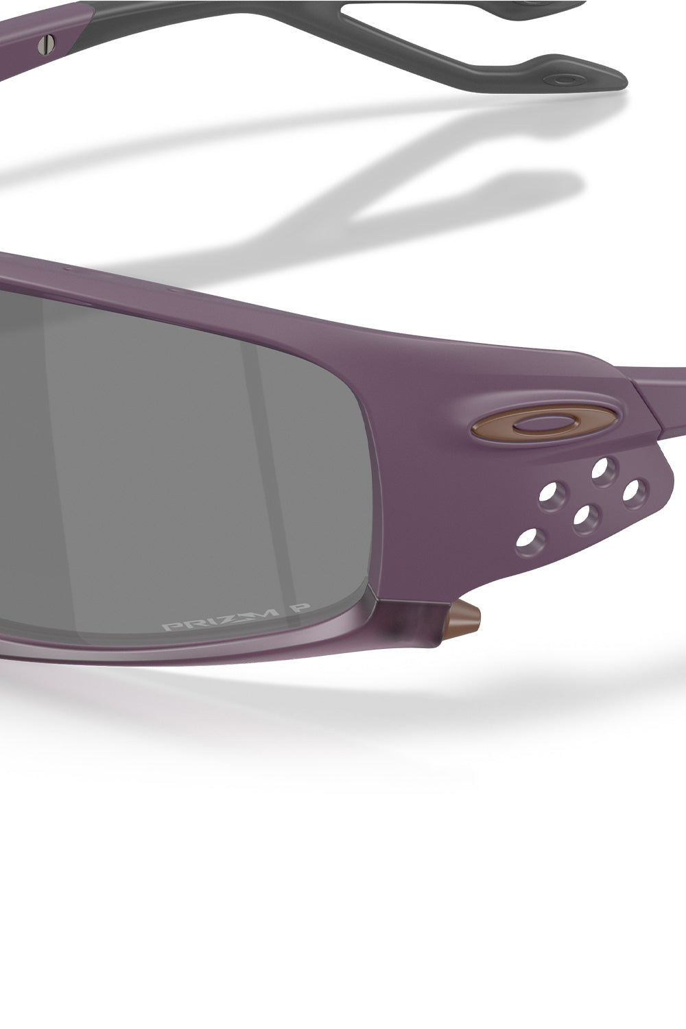 Macro close-up shot of the lateral temple hinge and side shield on the Oakley Plantaris SQ Matte Aubergine frame, highlighting the circular aeration holes, metallic bronze ellipse icon, and laser-etched Prizm P polarized lens branding.