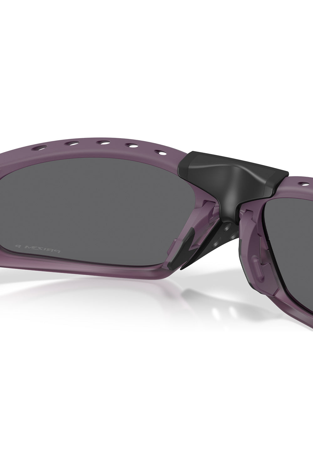 Interior close-up view of the Oakley Plantaris SQ Matte Aubergine frame, showing the clip-in mechanism of the removable black nose guard, inner brow ventilation slots, and textured no-slip Unobtainium nose pads.
