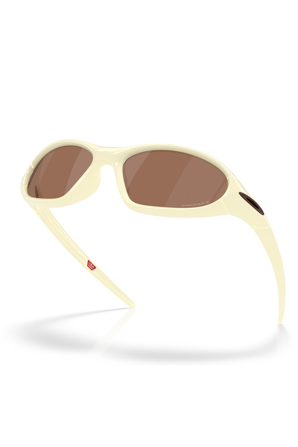 Floating three-quarter low-angle view of the cream Oakley Portal Jacket sunglasses, illustrating the deep curved wrap-around fit engineered for full eye coverage and glare reduction.