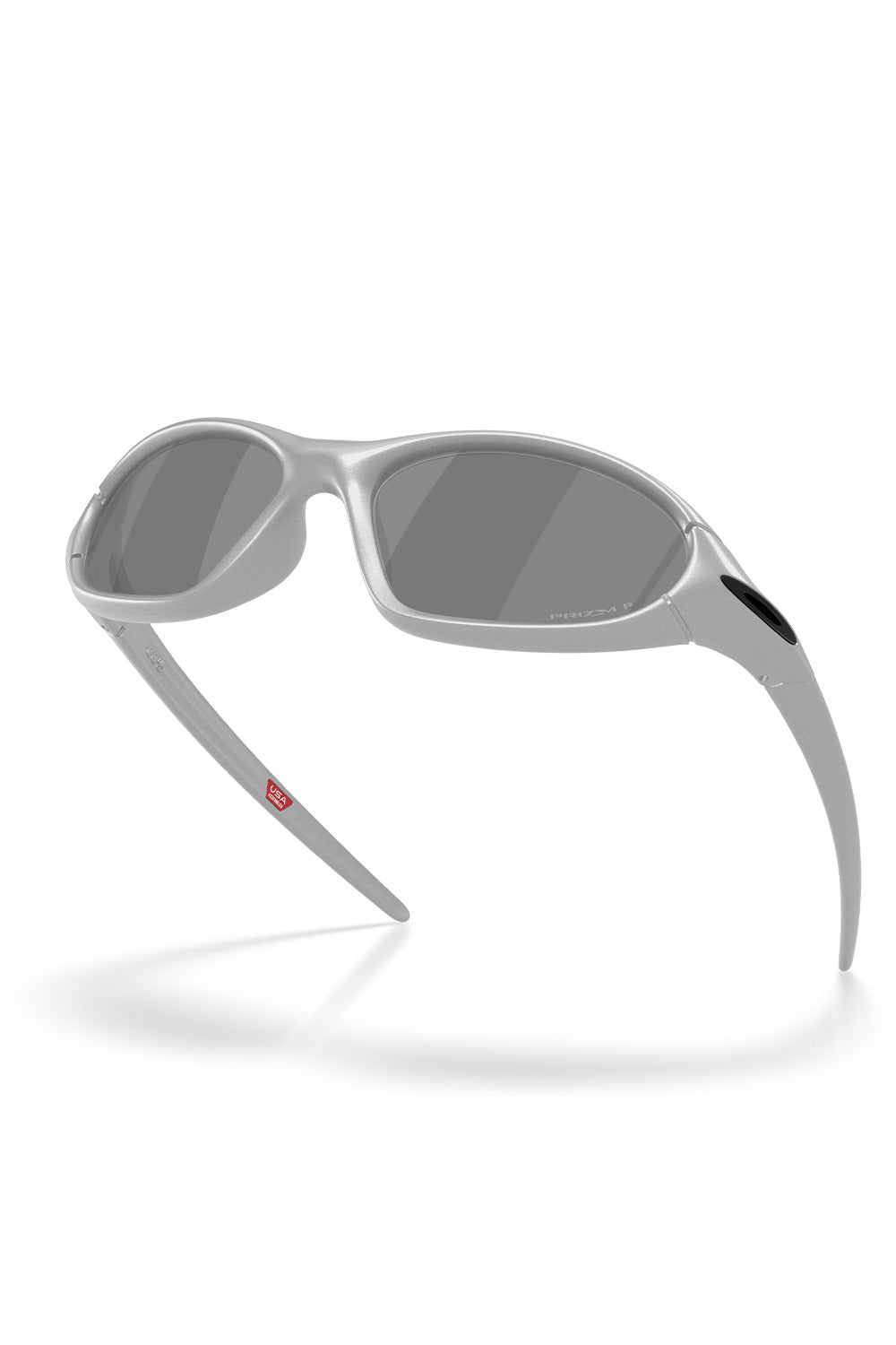 Floating three-quarter low-angle view of the metallic silver Oakley Portal Jacket sunglasses, illustrating the deep panoramic wrap design engineered for peripheral eye coverage and wind protection.