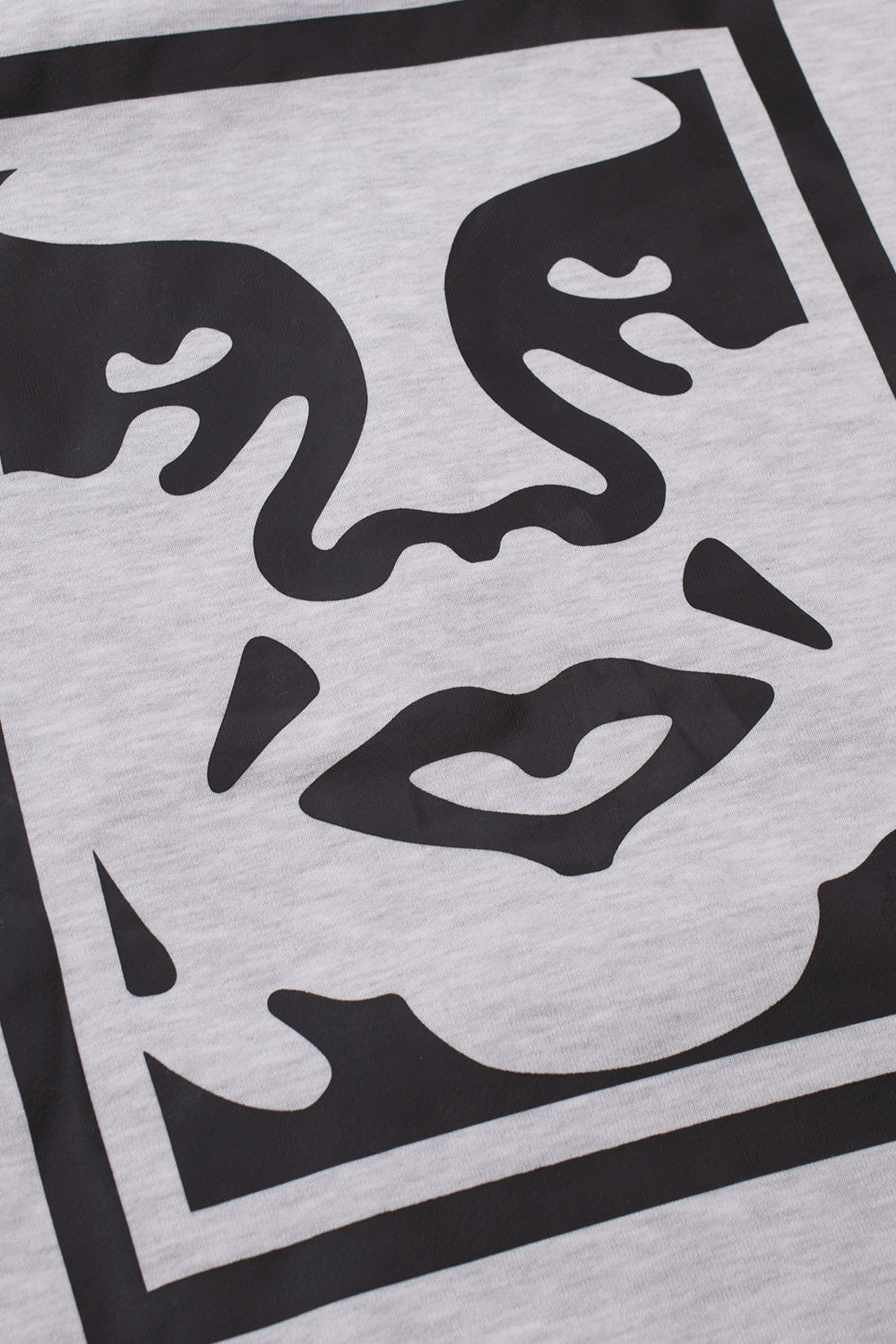 Close-up detail shot of the large black Shepard Fairey Giant face icon screen print on the mottled ash grey heavy fleece back of the Obey Bold Icon hoodie.