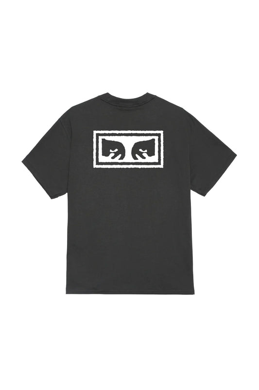 Back view of the washed vintage black Obey Eyes 3 T-Shirt, crafted from heavy 8oz 100% cotton jersey with a loose boxy fit, showcasing a large white screen-printed Shepard Fairey Giant Eyes box icon graphic across the upper back.
