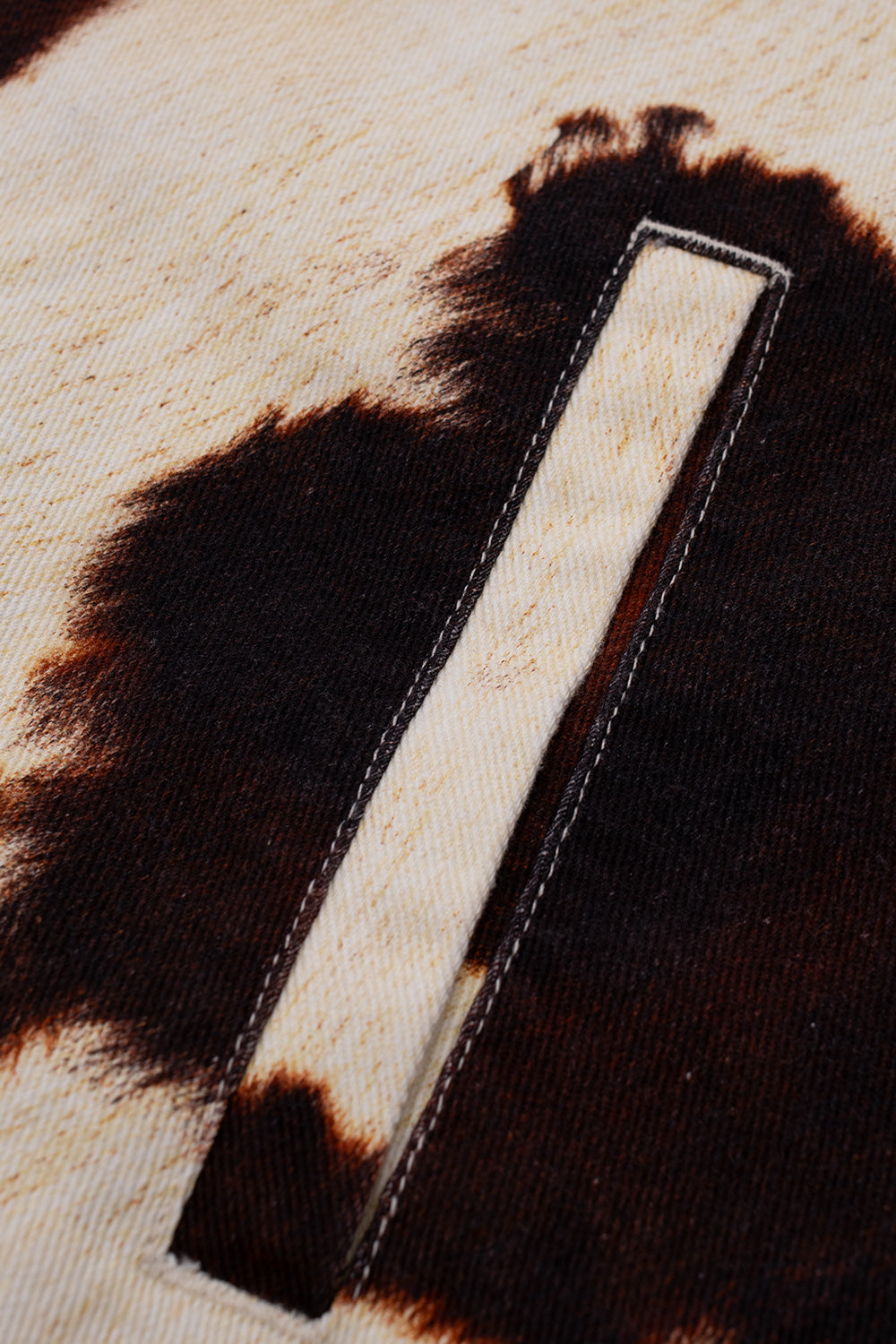 Close-up shot of the reinforced slanted front welt hand pocket on the Obey Workshop Jacket, highlighting the durable contrast stitching and rich brown-and-cream dyed denim twill.