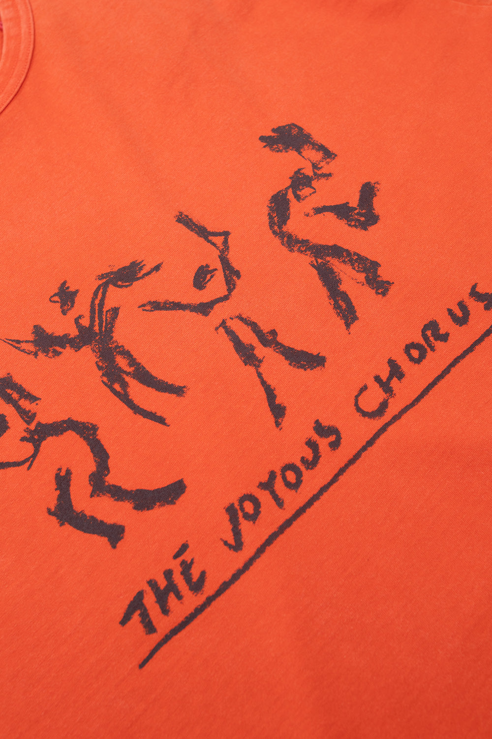 Close-up of Julian Klincewicz Joyous Chorus graphic print on OTW by Vans Mandarin Red t-shirt with artistic sketch artwork and premium vintage fade effect