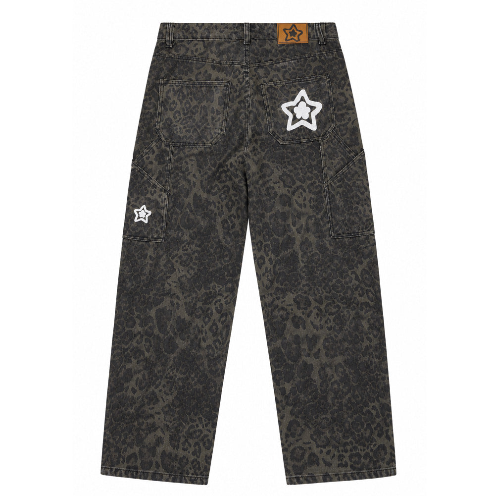 Back flat lay studio view of the Starteam East Village Leopard Star Jeans in faded olive green, showcasing a loose baggy skate fit cut from durable cotton denim covered in an allover muted charcoal leopard rosette print, featuring angular utility carpenter pockets along the side legs, a tan faux-leather jacron waistband patch with star graphics, and signature puffy white chain-stitched Starteam flower-star logo embroideries on the right rear pocket and right utility leg pocket.