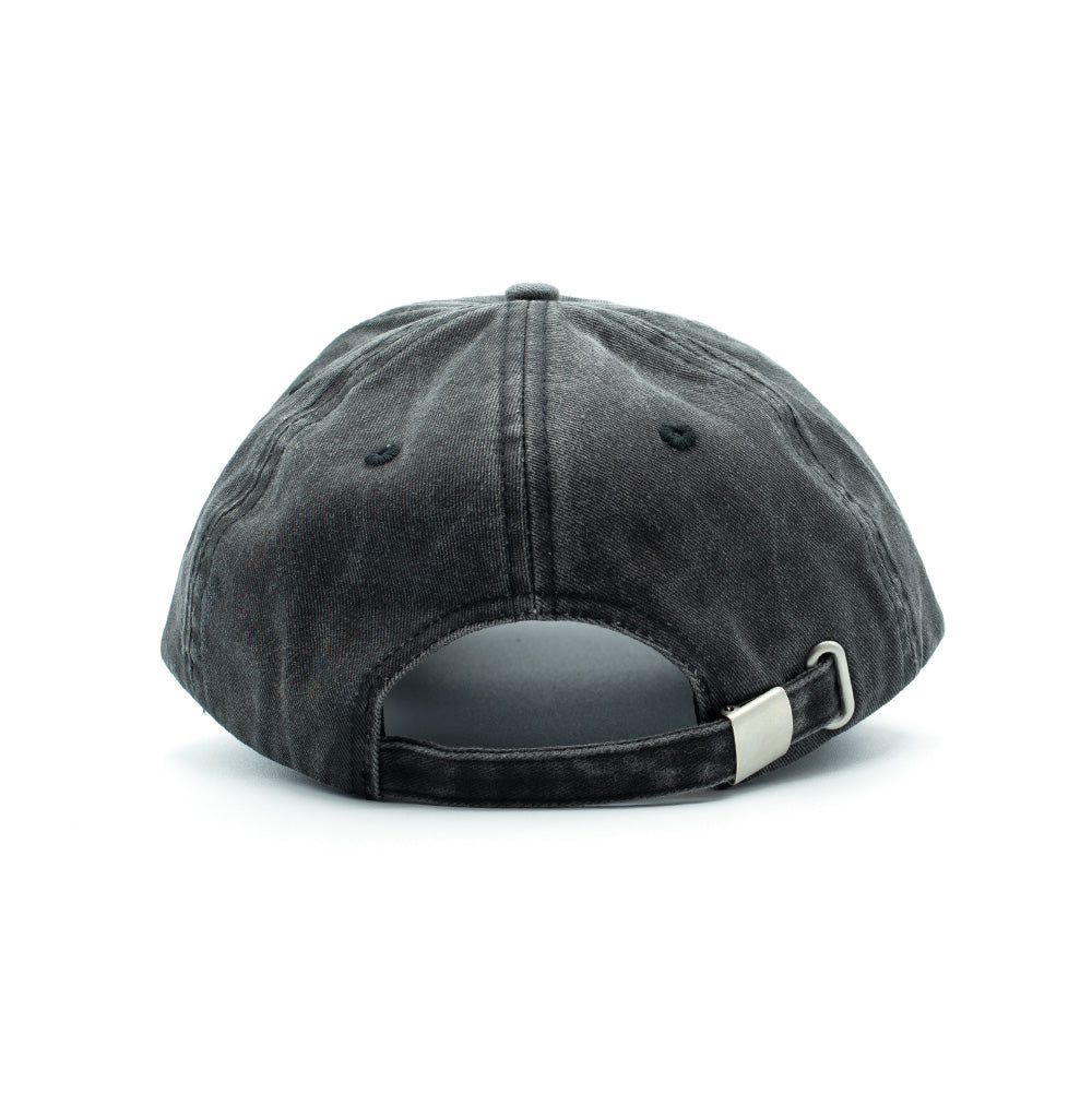 Back perspective of the Token Bae Cap, highlighting the unconstructed six-panel washed black denim-style cotton twill crown, sewn eyelets, stitched arch opening, and an adjustable matching self-fabric strap closure secured with an antique silver metal clasp.