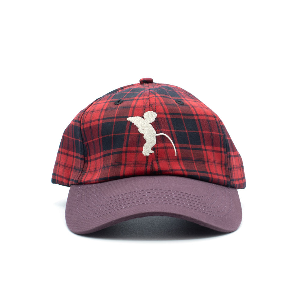 Front studio view of the Token Pissing Angel Cap, featuring an unstructured six-panel crown made from woven red and black tartan plaid fabric, embroidered on the front with a white satin-stitch Brussels Manneken Pis cherub angel motif, paired with a solid burgundy-brown curved visor with visible tonal brim stitching.