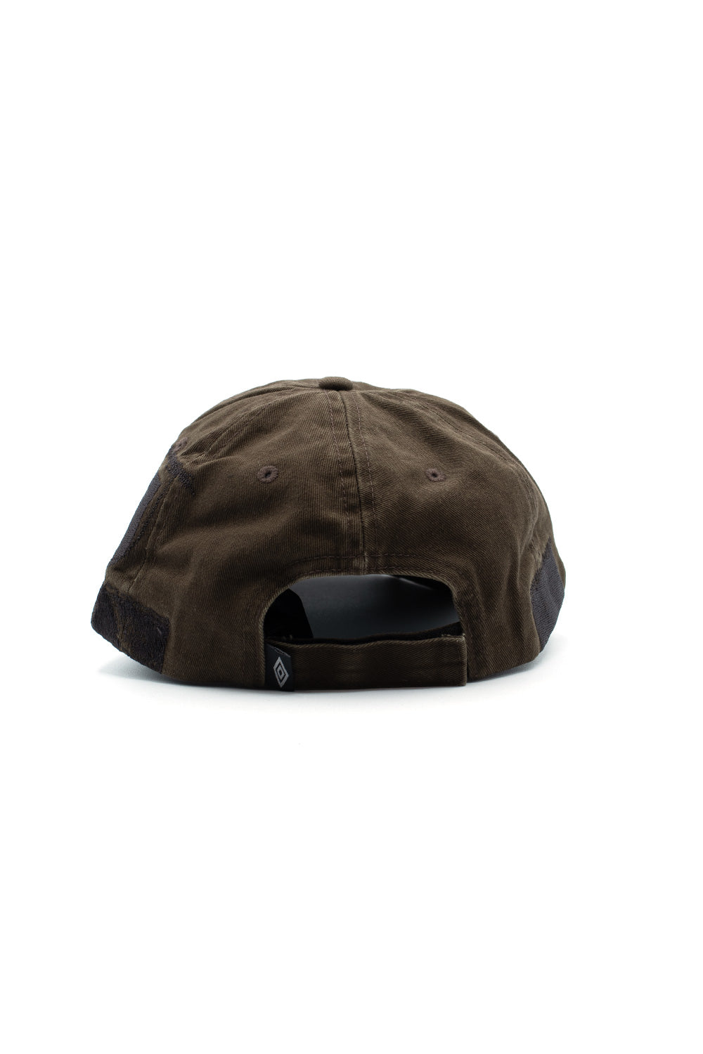 Rear perspective view of the Umbro Censored Cap, showcasing the washed cotton twill fabric, embroidered ventilation eyelets, side fabric patch overlays, open arch cut-out, and the adjustable matching olive-brown strap finished with a hook-and-loop Velcro closure and woven mini Umbro diamond label