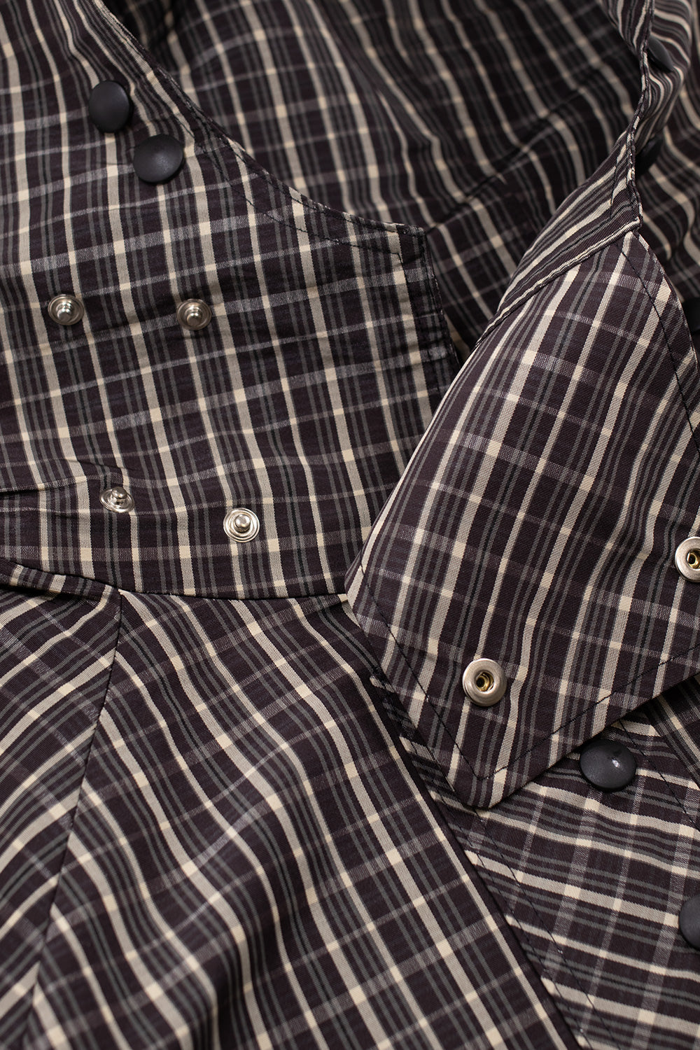 Detail view of snap-button placket and hood construction on Umbro Check Smock Anorak Beige Dark Brown with plaid pattern fabric