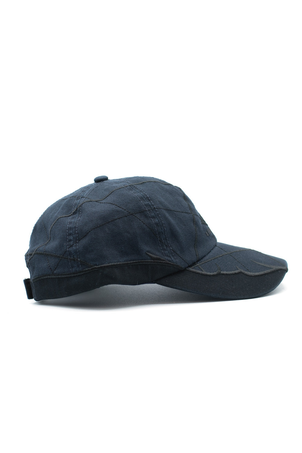 Side profile of Umbro Collision Cap showing stitched panel detailing, curved visor, and streetwear inspired sports cap design