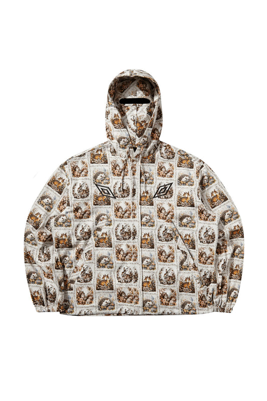 Front flat lay view of the Umbro Cub Masked Shirt in ivory, showcasing a boxy zip-and-button hooded jacket cut covered in a vintage tapestry-style floral print with woodland animals like deer, rabbits, hedgehogs, and squirrels, featuring elasticated cuffs, side pockets, black embroidered Umbro double diamond logos, and an integrated hood mask with a horizontal eye slit