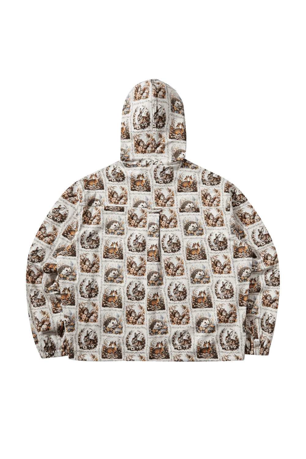 Back flat lay view of the ivory Umbro Cub Masked Shirt, displaying the full tapestry illustration of framed forest animals, a back storm flap with button detail, relaxed drop shoulders, elasticated waistband, and the contoured hood structure