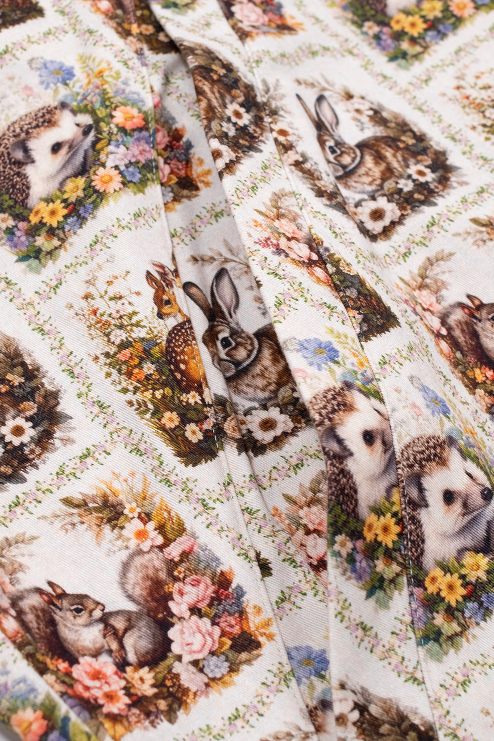 Macro angled perspective of the side welt pocket on the Umbro Cub Masked Shirt, showing the precision stitching, durable twill texture, and close-up floral motifs featuring hedgehogs and woodland hares