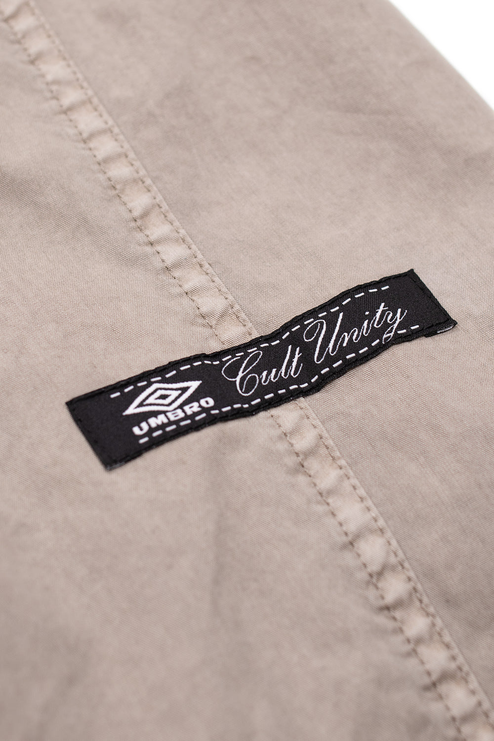 Woven Umbro Cult Unity label on grey faded smock anorak from Slam Jam collaboration collection