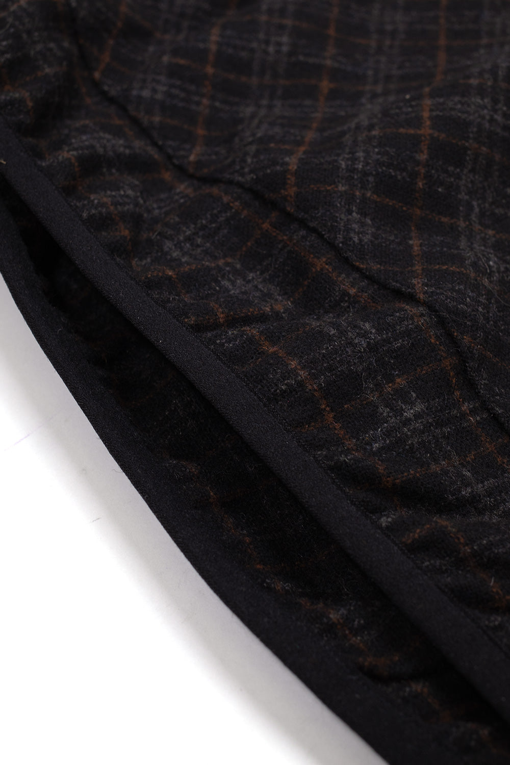 Macro detail of the kangaroo pocket opening on the Umbro Flannel Fur Anorak, revealing the reinforced bound edge trim and the soft insulating dark interior lining beneath the plaid exterior