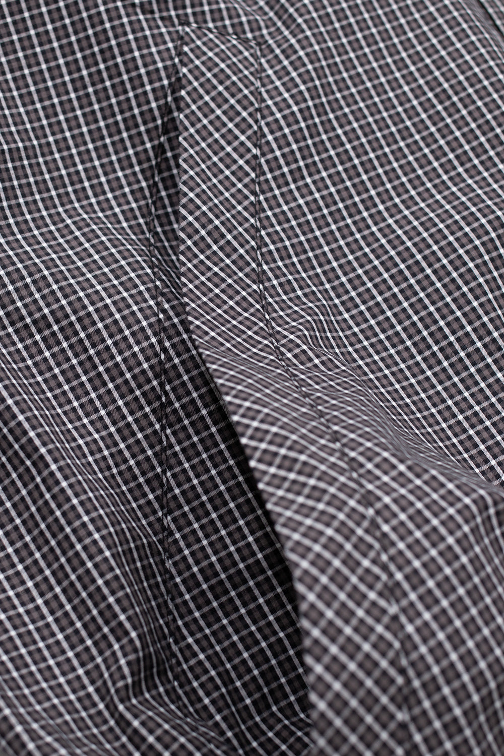 Umbro Gingham Masked Shirt in coffee brown and white featuring a loose fit silhouette, classic gingham check pattern and drawstring hood with integrated face mask, blending British sports heritage with modern streetwear design.