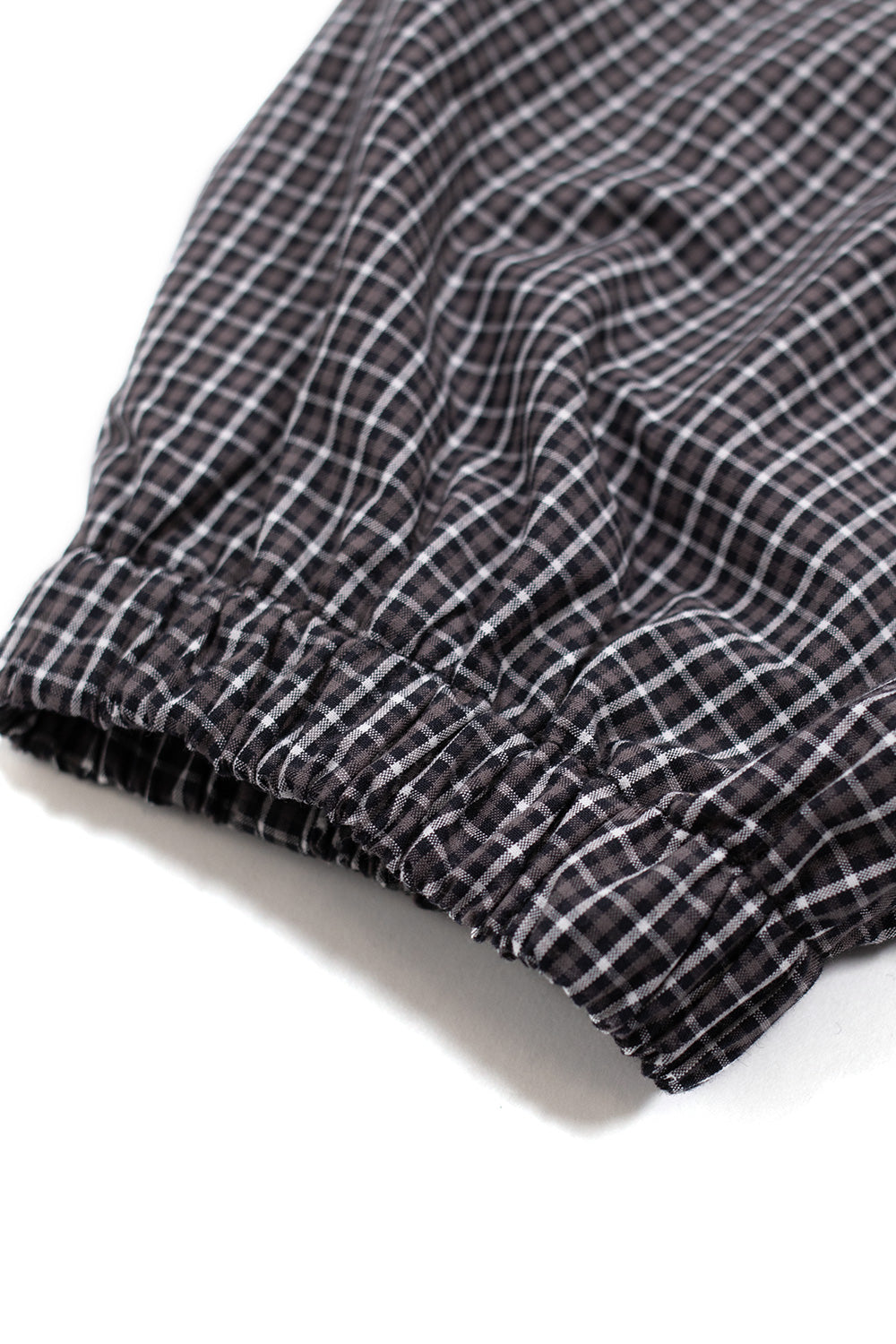 Elasticated cuff and hem detail of Umbro Gingham Masked Shirt, designed for comfort, structure and versatile everyday wear within modern urban street style.