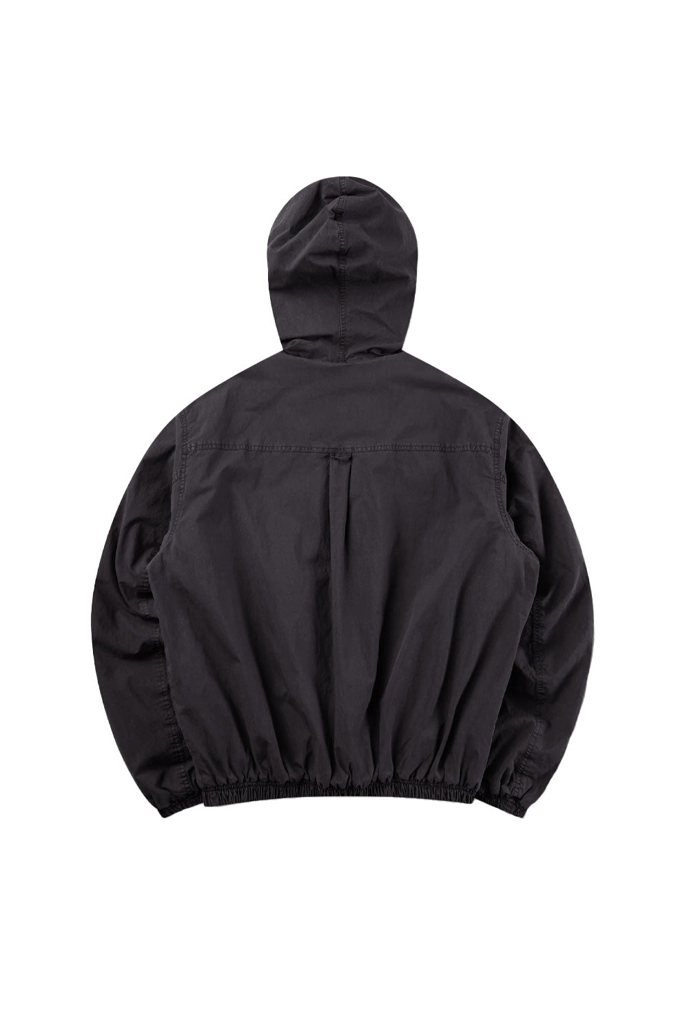 Back flat lay view of the washed black Umbro Sunday Masked Jacket, displaying the horizontal back shoulder yoke with a central vertical pleat loop, dropped shoulders, gathered elastic waistband, and the structured drape of the contoured hood