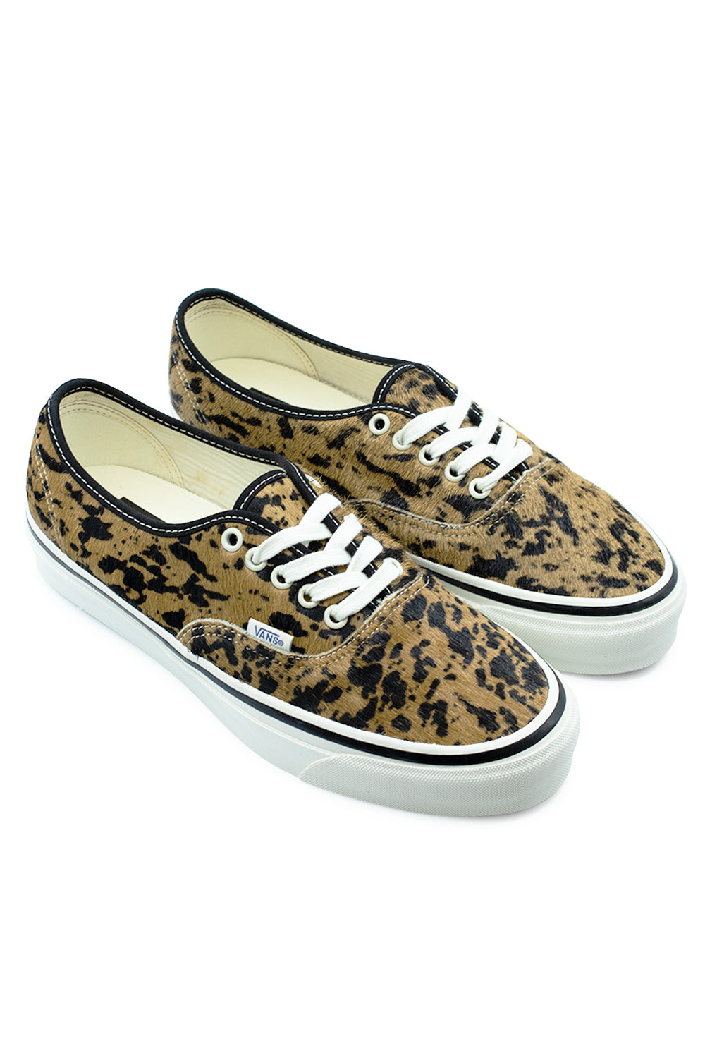 Three-quarter perspective studio shot of the Vans LX Authentic 44 Cow / Marshmallow shoes, showcasing the bold 70s punk aesthetic, tactile pony hair leather texture, high-gloss marshmallow midsole sidewall, and retro low-top silhouette.